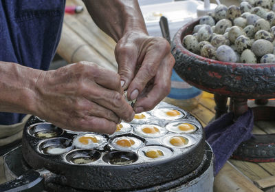 Midsection of man preparing food