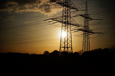 Low angle view of electricity pylon against sky