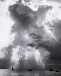 Sailboats in sea against sky