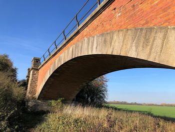 Low angle view of arch bridge against clear sky