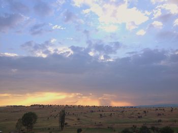 Scenic view of landscape against cloudy sky