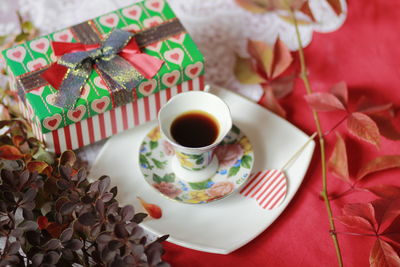 High angle view of coffee and cups on table