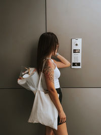 Portrait of young woman using phone