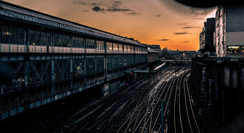 Train on railroad tracks against sky during sunset