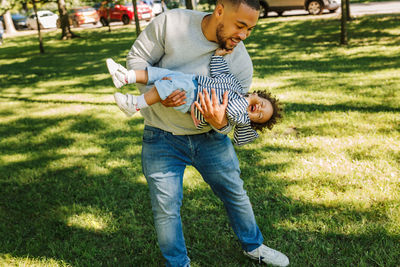 Full length of father and daughter on field