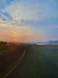 Dawn breaks over lake mcclure, creating a gorgeous colorful sky and a quiet peaceful atmosphere.