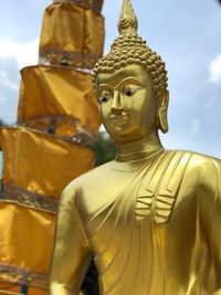 Close-up of buddha statue against trees
