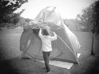 Rear view of man holding umbrella