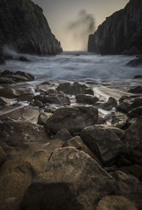 Rocks on beach against sky