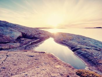 Seascape sunset or sunrise background with rich reflection in water pool. the  dramatic light.