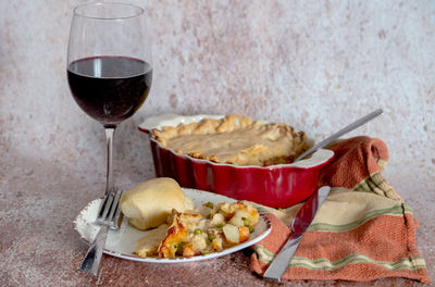  savory pie filled with chicken potatoes carrots peas, and a creamy gravy with a flaky pie crust top.