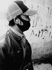 Portrait of man wearing hat against wall