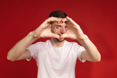 Portrait of young man against yellow background