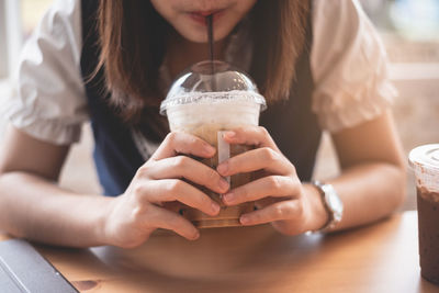 Midsection of woman holding ice cream