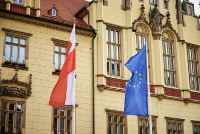 Low angle view of flag against buildings in city