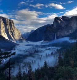 Scenic view of mountains against cloudy sky