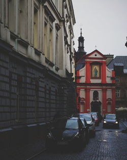 Cars on street amidst buildings in city