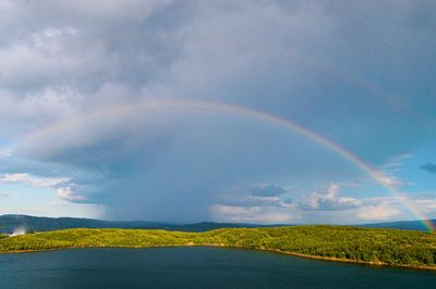 Rainbow over landscape against sky