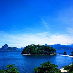 Scenic view of mountains against blue sky