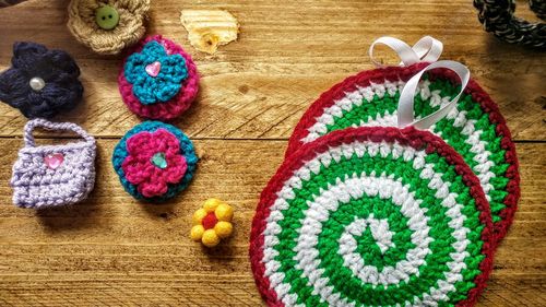 Directly above shot of knitted handicrafts on wooden table