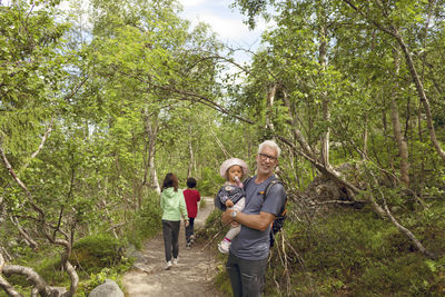 Father with toddler girl in forest