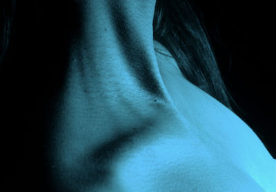 Midsection of woman against black background