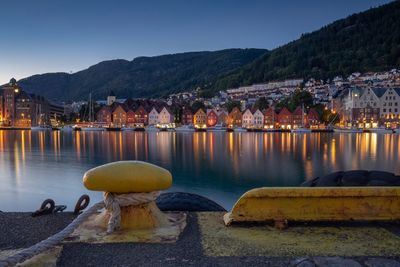 Scenic view of lake by buildings against clear sky