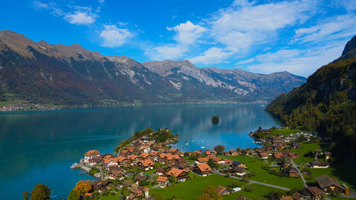 Scenic view of lake by mountains against sky