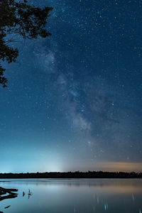 Scenic view of lake against star field at night