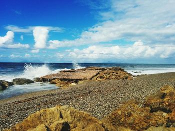 Scenic view of sea against cloudy sky