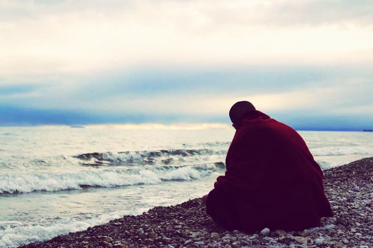 sea, rear view, sky, water, beach, leisure activity, shore, lifestyles, cloud - sky, scenics, beauty in nature, tranquil scene, horizon over water, tranquility, standing, nature, weather, looking at view