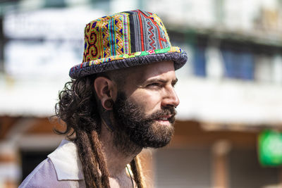 Close-up of bearded young man looking away