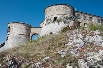 Low angle view of old building against clear sky