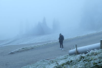 Man standing on snow covered land