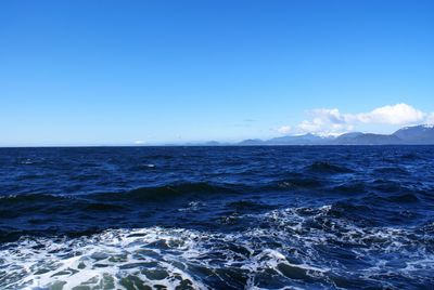 Scenic view of sea against blue sky