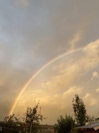 Low angle view of rainbow against sky at sunset