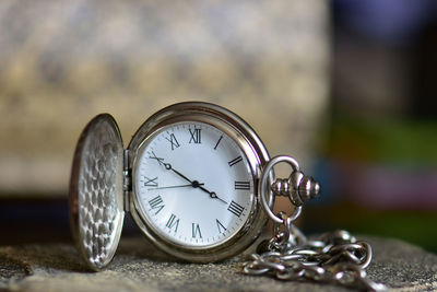 Close-up of pocket watch on table