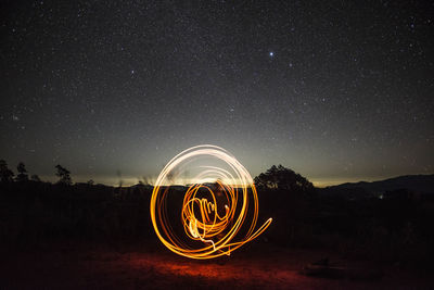 Light painting against sky at night