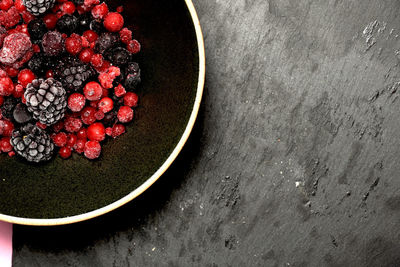 High angle view of berries in bowl on table