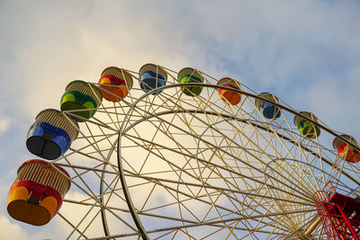 Low angle view of ferris wheel against sky