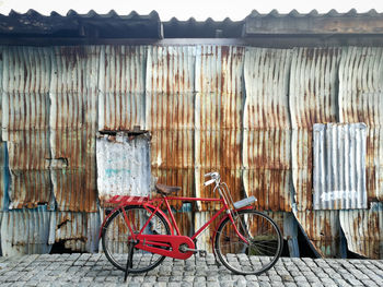 Bicycle parked against building