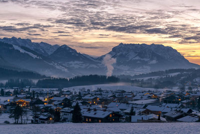 Scenic view of snowcapped mountains against sky during sunset