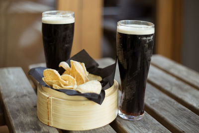 Beer glasses and prawn crackers on table