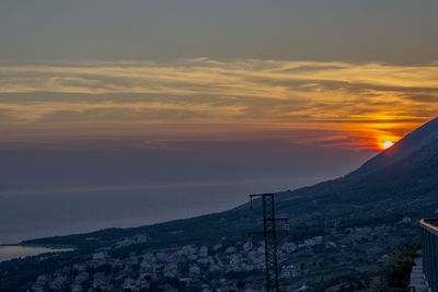 Scenic view of mountains against orange sky