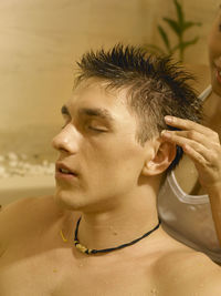 Close-up of woman massaging man in bathtub