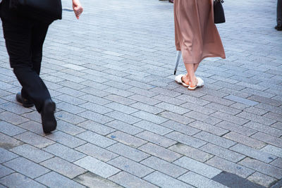 Low section of people walking on floor