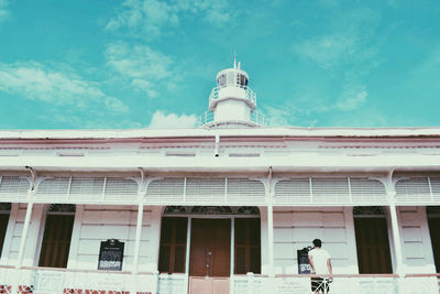 Low angle view of building against cloudy sky