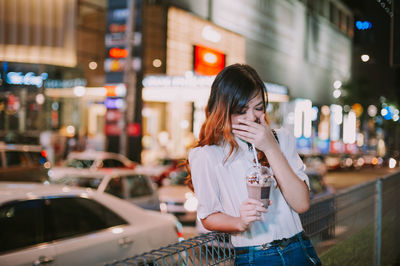 Woman standing on street in city