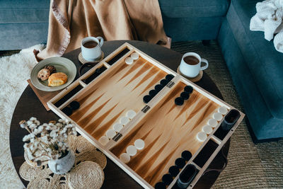 Low section of woman standing in container on table
