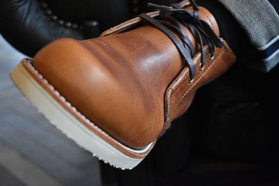 Close-up of man wearing brown leather shoe